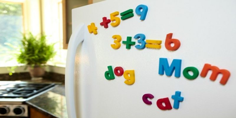 White fridge with Fisher Price refrigerator magnets