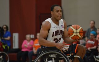 Mackenzie Johnson playing wheelchair basketball at Auburn University